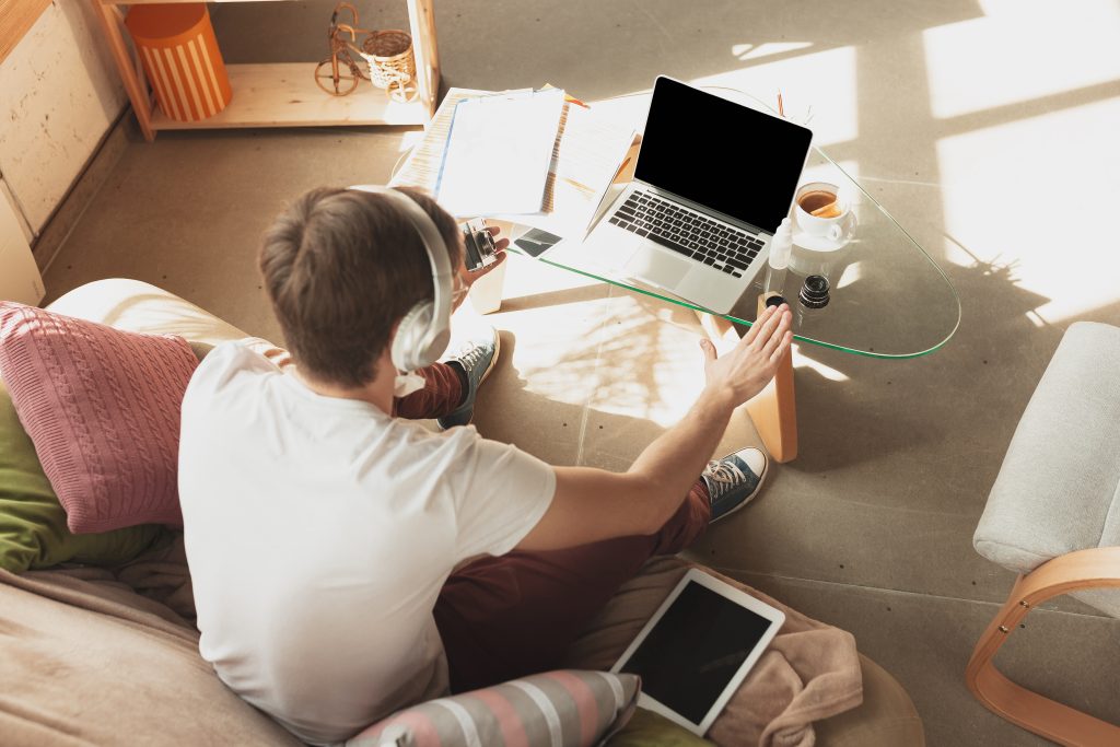 Young man studying at home during online courses