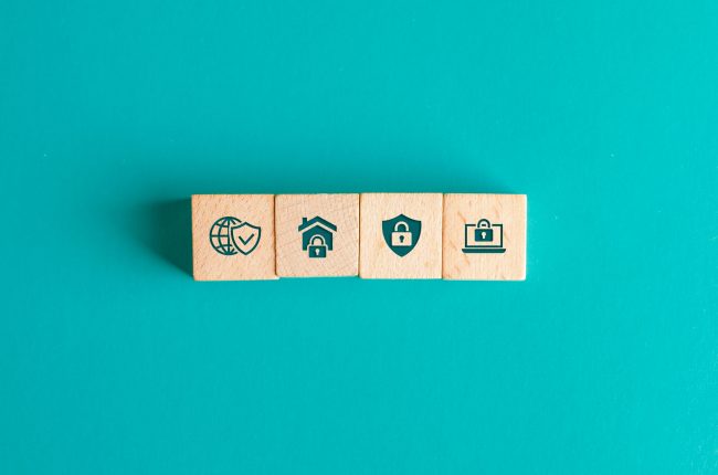 Security concept with icons on wooden blocks on turquoise background flat lay. Security concept with icons on wooden blocks on turquoise background